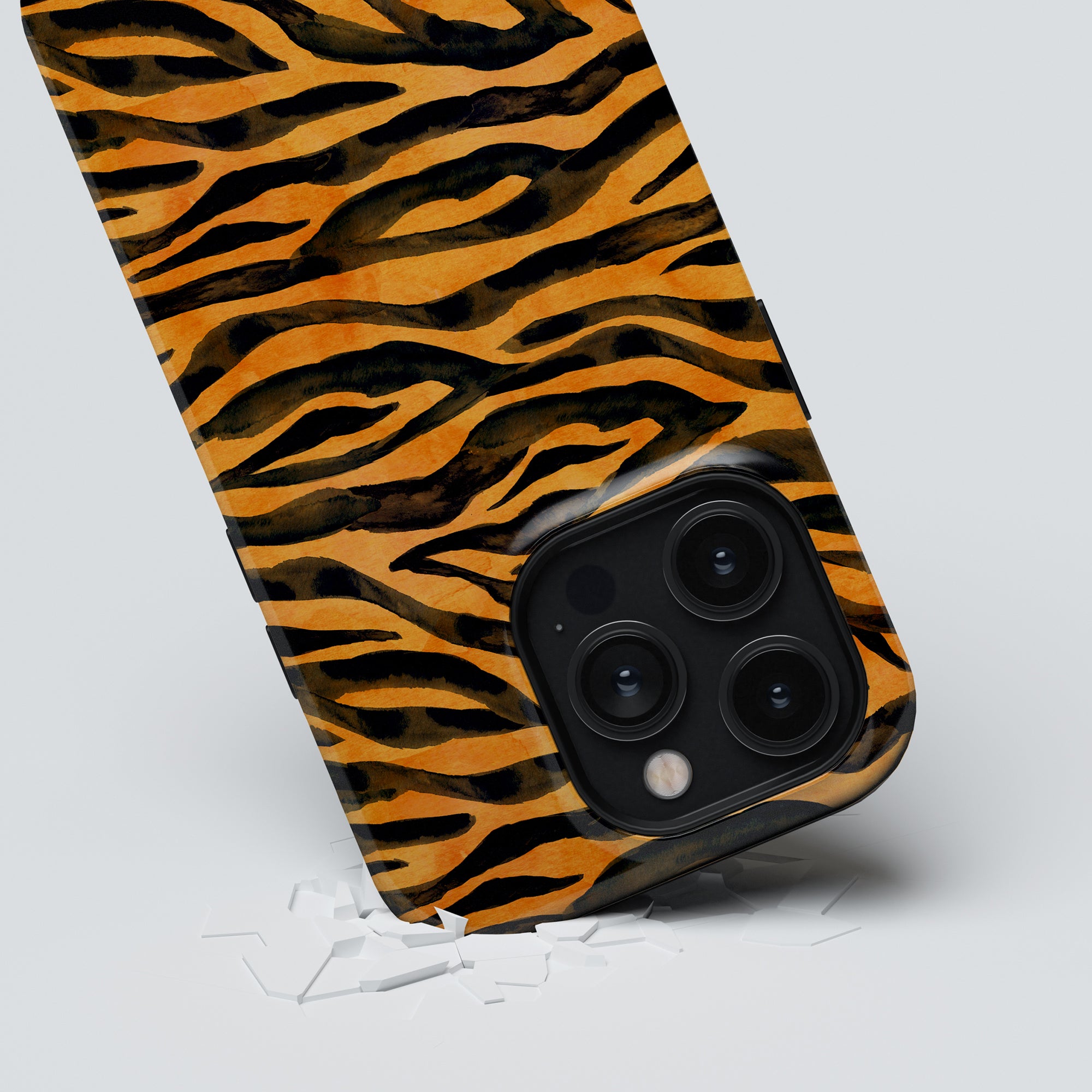 A smartphone with a Roar - Tough Case breaking through a white surface.